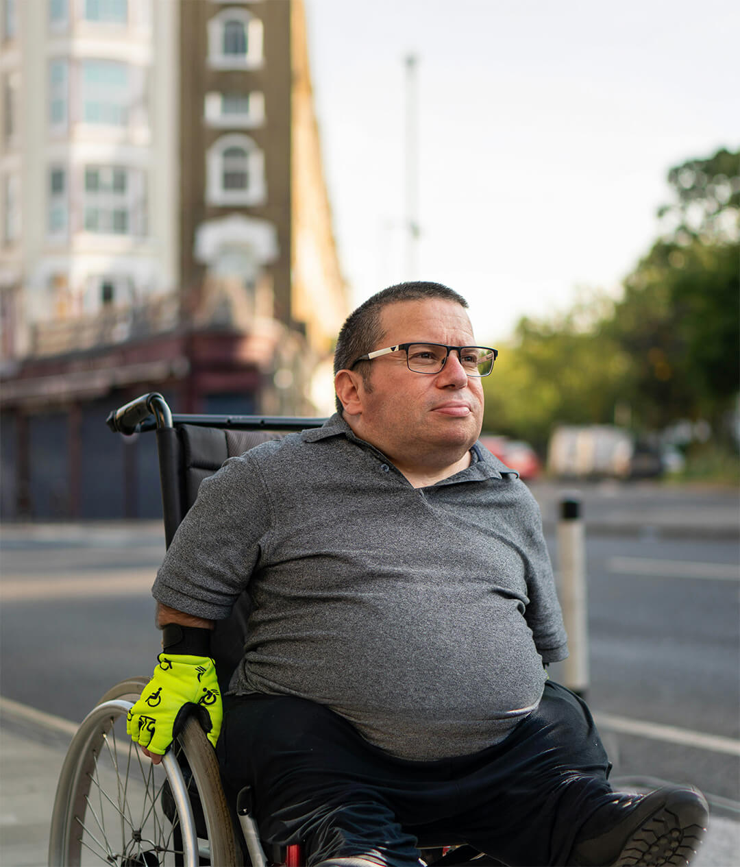 Man in a wheelchair outside in a city