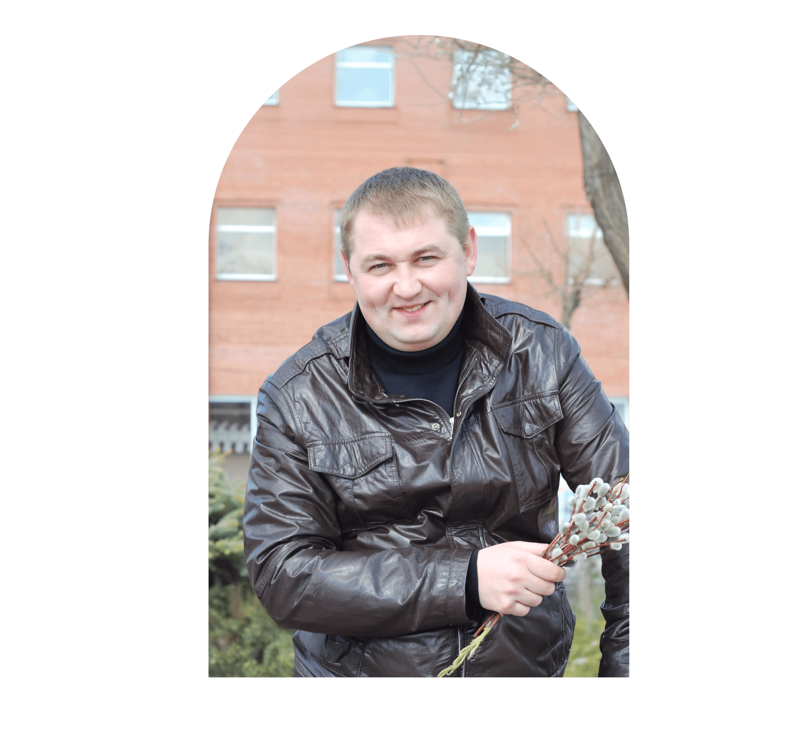 portrait-smiling-man-holding-flowers-while-sitting-outdoors-tinified(1)-tinified