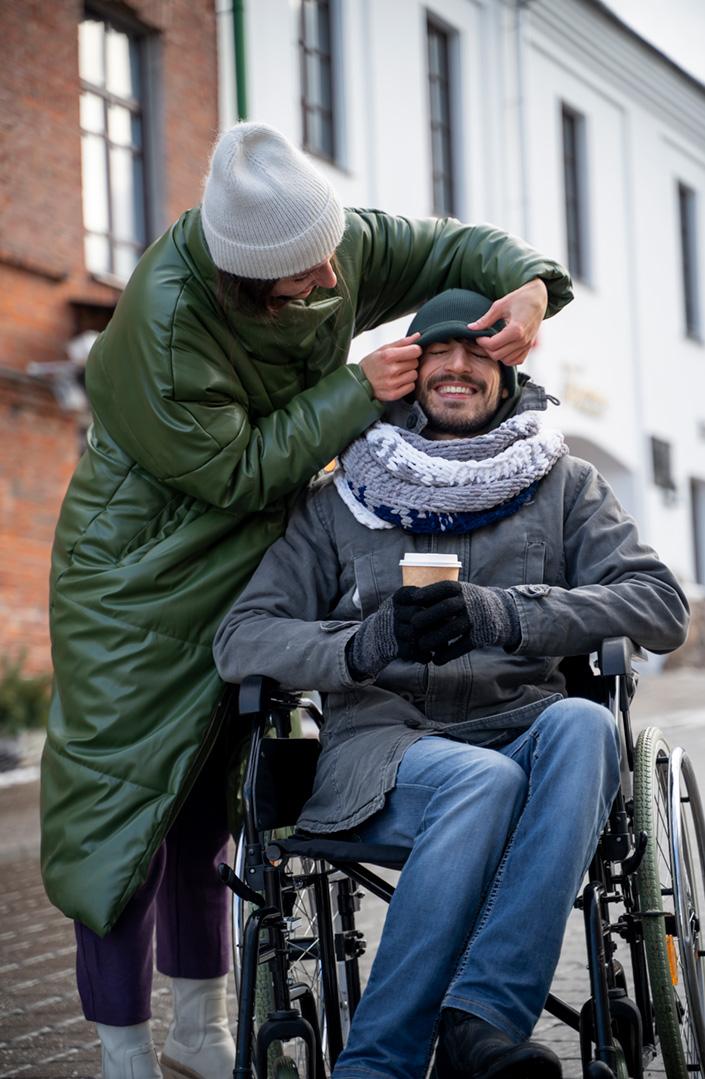 Woman helping a disabled friend in a wheelchaair